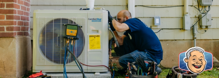 HVAC technician repairing an outdoor air conditioning unit with diagnostic gauges attached.